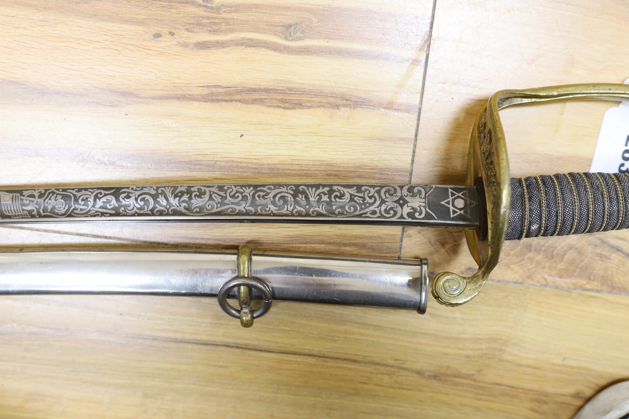 A United States Marines dress sword made by Wilkinson, the blade etched ‘S/SGT. JAMES P.S. DEVEREUX II. 1340836 U.S.M.C.’ with scabbard. Total length 107cm
